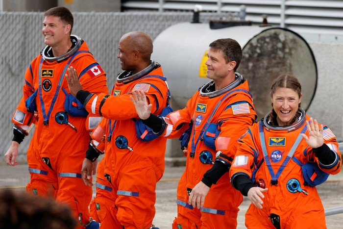 The crew of the Artemis II launch mission to fly by the moon, NASA astronauts Reid Wiseman, Victor Glover and Christina Koch and CSA (Canadian Space Agency) astronaut Jeremy Hansen greet people before boarding the astronaut van for their drive to launch pad 39B at the Kennedy Space Center in Cape Canaveral, Florida, U.S. April 1, 2026.  REUTERS/Joe Skipper