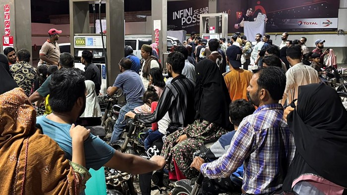 People on their vehicles wait for their turn to get fuel at a petrol station, as fuel prices in Pakistan rise, amid the U.S.-Israeli conflict with Iran, in Karachi, Pakistan, April 2, 2026. Picture taken with a mobile phone. REUTERS/Waseem Sattar