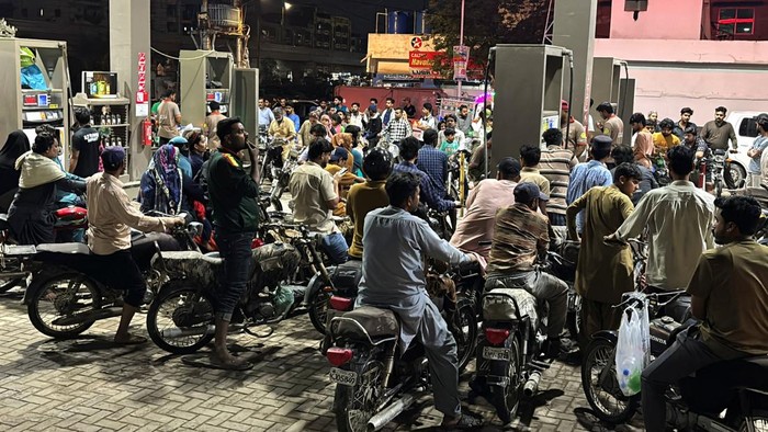 People on their vehicles wait for their turn to get fuel at a petrol station, as fuel prices in Pakistan rise, amid the U.S.-Israeli conflict with Iran, in Karachi, Pakistan, April 2, 2026. Picture taken with a mobile phone. REUTERS/Waseem Sattar