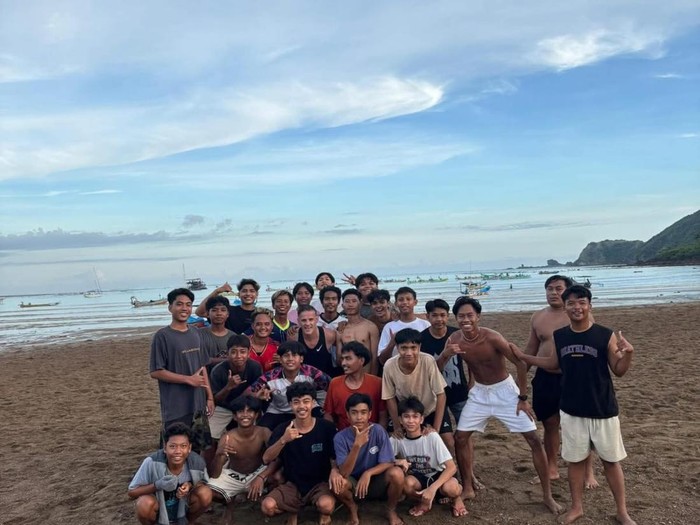 Pelatih Timnas Indonesia John Herdman berpose bersama warga lokal (warlok) di Pantai Kuta Mandalika, Kecamatan Pujut, Lombok Tengah, NTB. (Foto: Dok. Facebook @Putra_Coy)