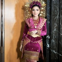 Mahkota suntiang yang dikenakan juga tak kalah jadi sorotan. Dengan hiasan bunga emas dan untaian ornamen menjuntai, suntiang tersebut memberikan kesan megah dan anggun khas pengantin adat. Foto: Instagram/@viennagallery