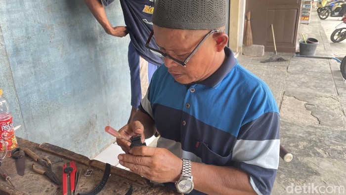 Histaria sedang memperbaiki jam tangan rusak di Pasar Pananjung.