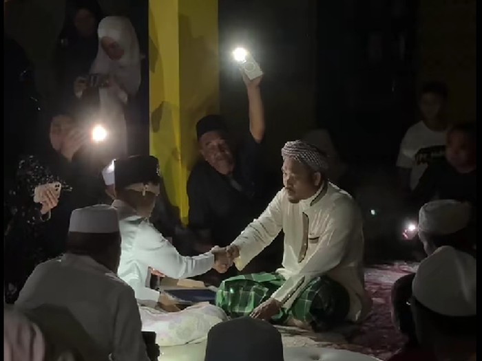 Listrik padam saat akad nikah di Kelantan tak halangi prosesi. Dibantu cahaya ponsel dan lilin dari tamu, suasana berubah romantis bak candle light dinner.