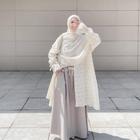 Permainan motif tampak pada outer panjang transparan dengan detail print bunga kecil yang manis di padu dengan gamis polos yang terdapat saku pada bagian samping. Khimar putih memberikan kesan anggun dan elegan untuk acara yang lebih formal. Foto: Dok. Instagram @denisarani.