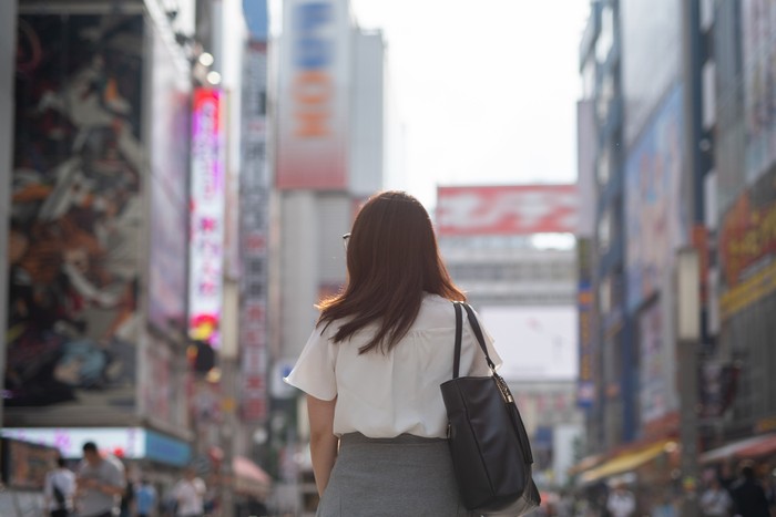 Woman walking in Akihabara, famous tourist spot in Japan