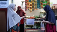 Sebuah papan bertuliskan ajakan membawa kantong belanja sendiri dipajang di sekitar lapak. Imbauan tersebut bersifat sementara mengikuti kondisi harga plastik yang meningkat. REUTERS/Ajeng Dinar Ulfiana