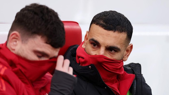 LIVERPOOL, ENGLAND - DECEMBER 13: Mohamed Salah of Liverpool sits on the bench, speaking to teammate Andrew Robertson during the Premier League match between Liverpool and Brighton & Hove Albion at Anfield on December 13, 2025 in Liverpool, England. (Photo by Carl Recine/Getty Images)