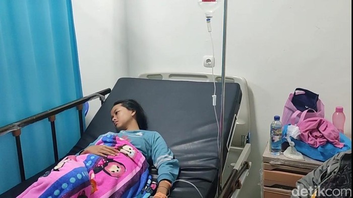 Salah seorang siswa yang mengalami gejala keracunan mendapatkan perawatan.