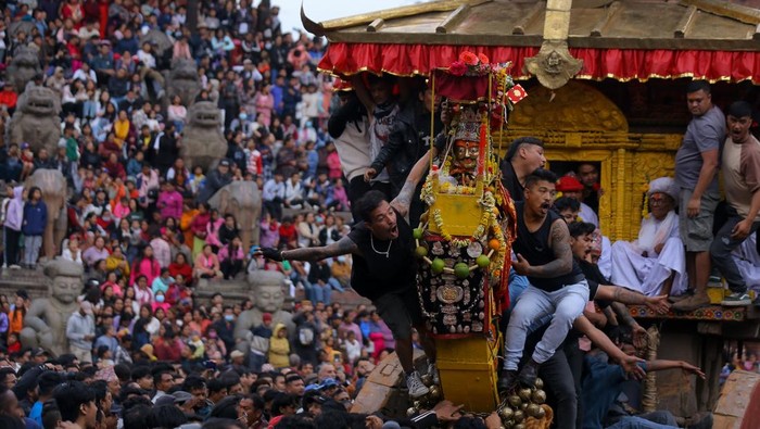 Nepali revelers pull the chariot of Lord Bhairav, marking the beginning of the eight-night, nine-day Biska celebration in Bhaktapur, Nepal, on April 10, 2026. According to folklore, the Biska: Jatra starts the countdown for the Nepali New Year. As one of the popular religious festivals of the Kathmandu Valley, the event begins with the ascension of Lord Bhairav onto a chariot built in front of the Nayatapola Temple, the tallest temple in Nepal. The three-story chariot, made of wood in the pagoda style, is pushed and pulled around the settlements with statues of Bhairavnath and Betal as part of the festival. Two groups of locals engage in a tug-of-war to pull the chariot to either side, a tradition that has been followed for generations. This festival of cultural and historical significance is celebrated for nine days and eight nights. (Photo by Subaas Shrestha/NurPhoto via Getty Images)