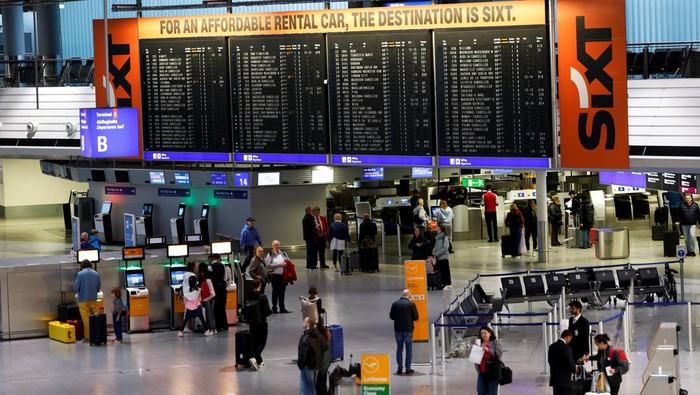 A person points at an information panel that shows flights, many of which are cancelled, during a strike by the UFO union, representing Lufthansa cabin crew, at Frankfurt Airport, Germany, April 10, 2026. REUTERS/Heiko Becker