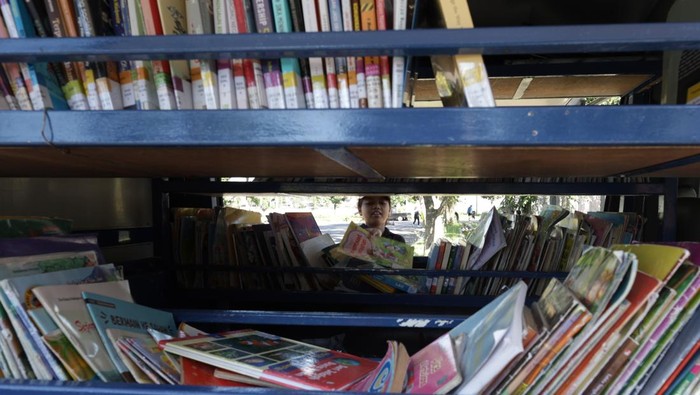 Seorang anak memilih buku koleksi perpustakaan keliling di GOR Jayabaya, Kota Kediri, Jawa Timur, Minggu (12/4/2026). Perpustakaan keliling yang beroperasi setiap hari minggu di ruang publik tersebut menyediakan sejumlah buku bacaan bermutu guna meningkatkan minat baca pelajar dan mendukung Peraturan Pemerintah Nomor 17 Tahun 2025 tentang Tata Kelola Penyelenggaraan Sistem Elektronik dalam Perlindungan Anak (PP Tunas). ANTARA FOTO/Prasetia Fauzani