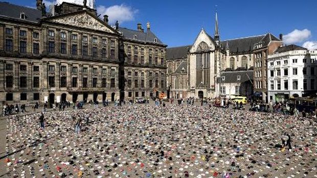 A photo shows children's shoes layed out on Dam Square during a memorial protest organised by Plant an Olive Tree group for child victims in Gaza, in Amsterdam, on April 12, 2026. (Photo by Ramon van Flymen / ANP / AFP) / Netherlands OUT