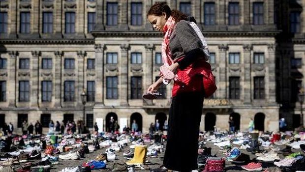 A photo shows children's shoes layed out on Dam Square during a memorial protest organised by Plant an Olive Tree group for child victims in Gaza, in Amsterdam, on April 12, 2026. (Photo by Ramon van Flymen / ANP / AFP) / Netherlands OUT