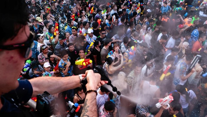 Revellers play with water as they celebrate the Songkran holiday, which marks the Thai New Year, at Khaosan Road, one of the favourite tourist spots in Bangkok, Thailand, April 13, 2026. REUTERS/Patipat Janthong