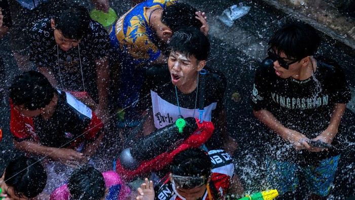 Revellers play with water as they celebrate the Songkran holiday, which marks the Thai New Year, at Khaosan Road, one of the favourite tourist spots in Bangkok, Thailand, April 13, 2026. REUTERS/Patipat Janthong