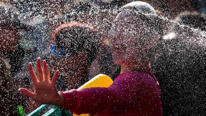 Revellers play with water as they celebrate the Songkran holiday, which marks the Thai New Year, at Khaosan Road, one of the favourite tourist spots in Bangkok, Thailand, April 13, 2026. REUTERS/Patipat Janthong