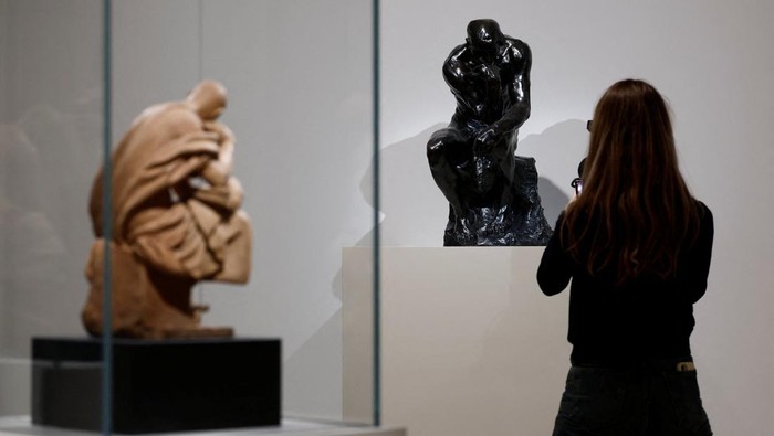 Saint Mark (1573) modeling by Andrea Corsali and The Thinker (1881-1882) sculpture by French sculptor Auguste Rodin stand on display during a press visit of the 