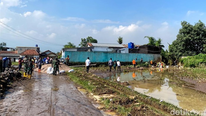Petugas melakukan pemasangan bronjong dan tanggul sementara di aliran Sungai Cisunggalah