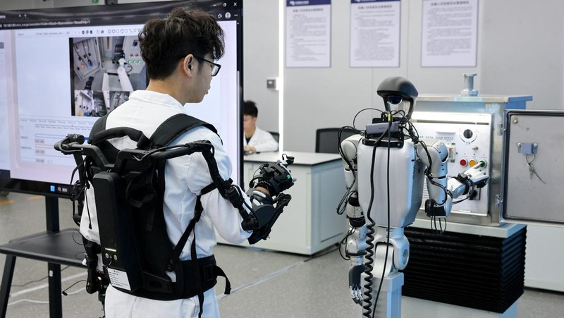 Robotic arms demonstrate maintaining high-voltage power lines at China Southern Power Grid's robotics laboratory during a government-organized media trip in Guangzhou, Guangdong province, China, April 16, 2026.  REUTERS/Go Nakamura