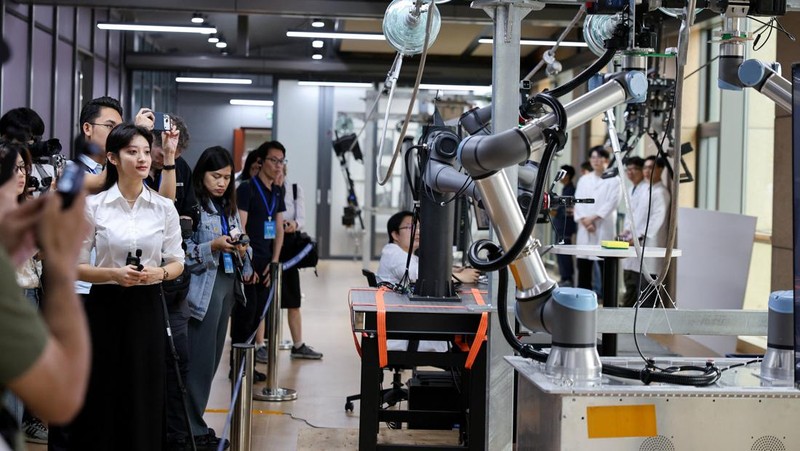 Robotic arms demonstrate maintaining high-voltage power lines at China Southern Power Grid's robotics laboratory during a government-organized media trip in Guangzhou, Guangdong province, China, April 16, 2026.  REUTERS/Go Nakamura