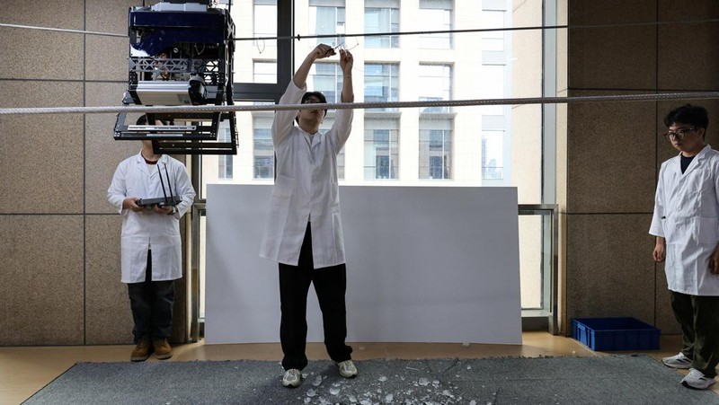 Robotic arms demonstrate maintaining high-voltage power lines at China Southern Power Grid's robotics laboratory during a government-organized media trip in Guangzhou, Guangdong province, China, April 16, 2026.  REUTERS/Go Nakamura