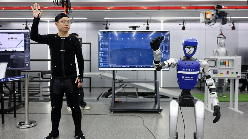 Robotic arms demonstrate maintaining high-voltage power lines at China Southern Power Grid's robotics laboratory during a government-organized media trip in Guangzhou, Guangdong province, China, April 16, 2026.  REUTERS/Go Nakamura