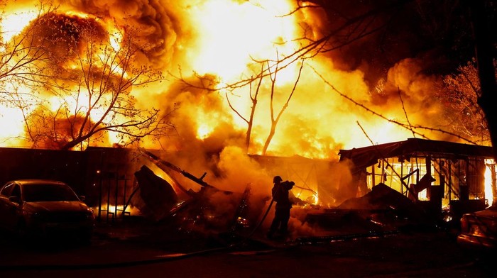 A firefighter works at the site of recycling materials hit by a Russian missile strike, amid Russia's attack on Ukraine, in Kyiv, Ukraine, April 16, 2026. REUTERS/Valentyn Ogirenko