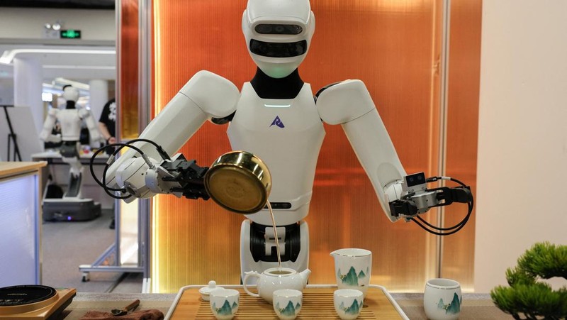 An Astribot humanoid robot demonstrates serving tea at the Robot Valley Exhibition Hall during a government‑organised media trip in Shenzhen, Guangdong province, China, April 16, 2026.  REUTERS/Go Nakamura