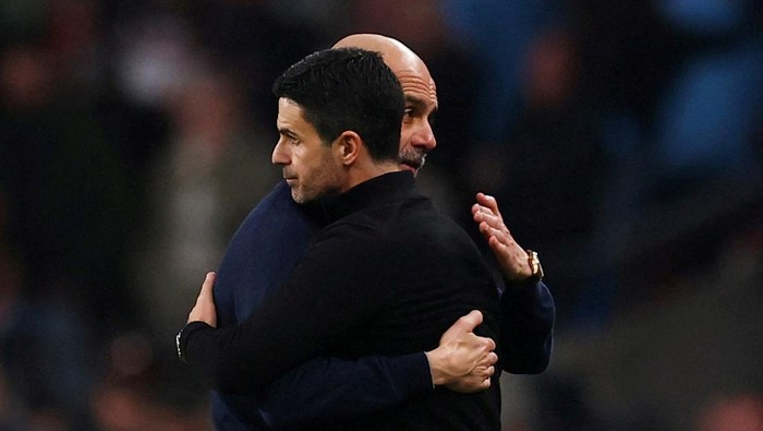 FILE PHOTO: Soccer Football - Carabao Cup - Final - Arsenal v Manchester City - Wembley Stadium, London, Britain - March 22, 2026 Manchester City manager Pep Guardiola embraces Arsenal manager Mikel Arteta after winning the Carabao Cup Action Images 