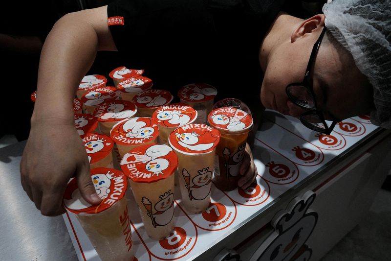 Employees of Chinese ice cream and beverage chain Mixue check freshly prepared drinks at the company's first Brazilian store ahead of its opening to the public, marking the brand's arrival in South America amid a fresh tide of Chinese investment, in Sao Paulo, Brazil, April 9, 2026. REUTERS/Alexandre Meneghini