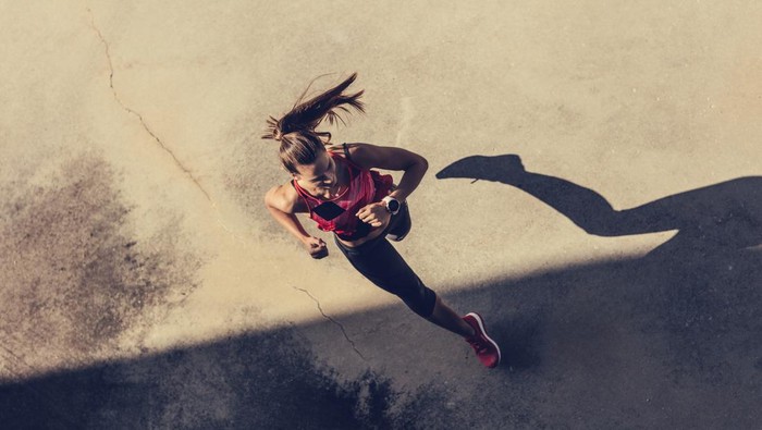 Women running in to the shadow