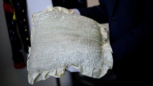 Kepala Departemen Pop Culture and Memorabilia Aguttes, Arthur Perault, memegang bantalan berlian imitasi milik Michael Jackson di Neuilly-sur-Seine, dekat Paris, Prancis, Kamis (23/4/2026). Aksesori tersebut menjadi salah satu item yang akan dilelang dalam koleksi khusus sang King of Pop. REUTERS/Sarah Meyssonnier