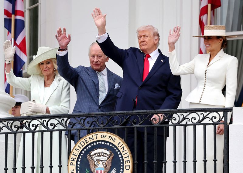 Queen Camilla, King Charles III, U.S. President Donald Trump and First Lady Melania Trump wave as they watch a 'Pass in Review' from the balcony of the South Portico during the State Arrival Ceremony on the South Lawn on day two of the State Visit of King Charles III and Queen Camilla to the United States of America, on April 28, 2026 in Washington, DC.    Chris Jackson/Pool via REUTERS