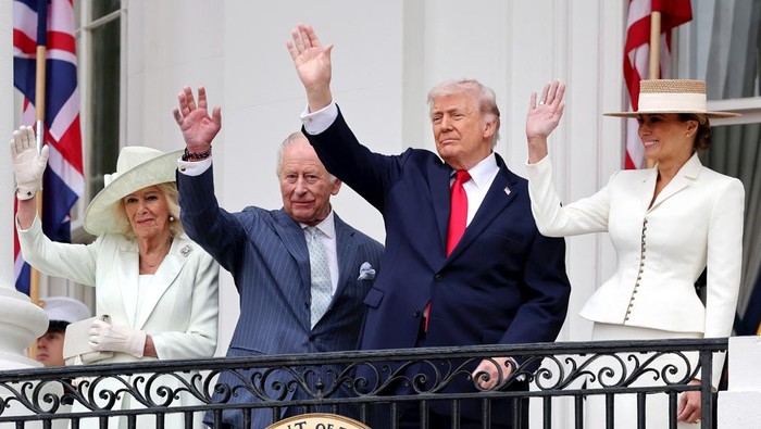 Queen Camilla, King Charles III, U.S. President Donald Trump and First Lady Melania Trump wave as they watch a Pass in Review from the balcony of the South Portico during the State Arrival Ceremony on the South Lawn on day two of the State Visit of