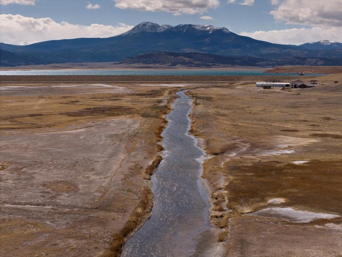 An angler fishes in the Antero Reservoir ahead of a planned full drainage, under an unlimited fishing salvage request allowing fish to be removed before drawdown, amid the ongoing drought in Park County, Colorado, U.S., April 28, 2026. REUTERS/Cheney Orr