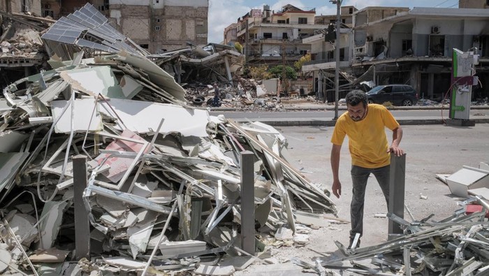 A worker clears a destroyed shopping building, amid a temporary ceasefire between Lebanon and Israel, in Tyre, southern Lebanon, April 28, 2026. REUTERS/Marko Djurica