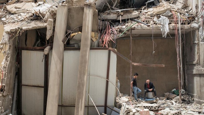 A worker clears a destroyed shopping building, amid a temporary ceasefire between Lebanon and Israel, in Tyre, southern Lebanon, April 28, 2026. REUTERS/Marko Djurica