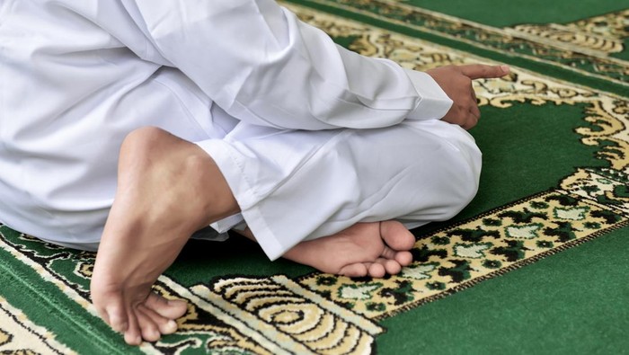 Portrait of muslim man praying to god inside the mosque