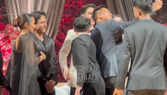 Sementara Zahwa tampil dengan dress bodycon dipadukan dengan cape berbahan organza yang menerawang. Penampilannya simpel dengan rambut sleek bun. Foto: YouTube/ AHMAD DHANI DALAM BERITA