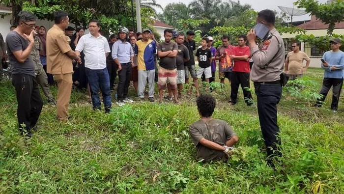 pelaku pembongkaran makam di Simalungun saat diamankan warga. (Dok Polres Simalungun)