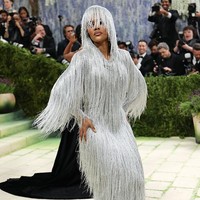 Teyana Taylor yang merupakan bagian dari komite tuan rumah Met Gala 2026, mengenakan gaun perak berumbai rancangan Tom Ford lengkap dengan hiasan kepala senada yang menjuntai menutupi setengah wajahnya. “Gaunnya terlihat seperti meleleh saat saya bergerak. Saya suka menganggapnya sebagai ‘hantu dari sebuah tubuh,’ yang muncul dan menghilang, muncul dan menghilang seiring saya bergerak,” kata aktris One Battle After Another. Foto: Getty Images/Mike Coppola