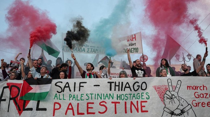 Protesters hold flares with the colours of the Palestinian flag, during a demonstration calling for the release of Saif Abu Keshek and Brazilian Thiago Avila, who were detained aboard a Gaza-bound flotilla that was intercepted by Israeli forces in international waters near Greece, while an Israeli court extended their detention until May 10, in Athens, Greece, May 5, 2026. REUTERS/Louisa Gouliamaki