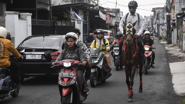 Aparatur Sipil Negara (ASN) Pemerintah Kota Tasikmalaya Mohammad Arif Syamsani menunggang kuda saat berangkat kerja pada program hari bebas kendaraan bermotor (car free day) di Kota Tasikmalaya, Jawa Barat, Rabu (6/5/2026). Pemerintah Kota Tasikmalaya membatasi penggunaan kendaraan dinas hingga 50 persen serta mendorong ASN beralih ke transportasi publik dan efisiensi perjalanan dinas untuk menekan penggunaan BBM. ANTARA FOTO/Adeng Bustomi/bar