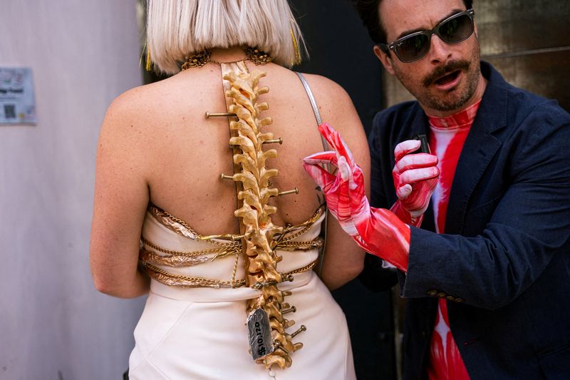 A woman wearing a recreation of her own spinal surgery, which she says cost her $10,120 to undergo, arrives at the annual Debt Gala, a budget-friendly, inclusive alternative to the Met Gala that fundraises for medical debt for vulnerable Americans, in Brooklyn, New York, U.S., May 3, 2026. REUTERS/Angelina Katsanis