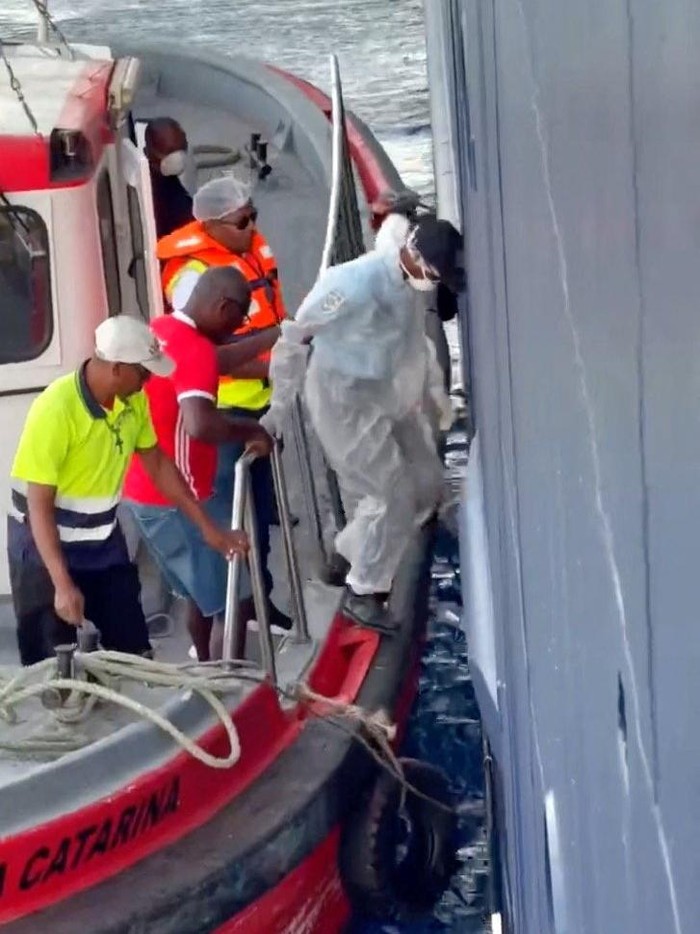 A member of medical personnel boards a ship from a medical boat, after an outbreak of the deadly hantavirus on board the cruise ship MV Hondius, at sea, in this still image from a social media video released May 5, 2026. Kasem Ibn Hattuta/via REUTERS  THIS IMAGE HAS BEEN SUPPLIED BY A THIRD PARTY. MANDATORY CREDIT. NO RESALES. NO ARCHIVES.  VERIFICATION: The exact date and locations at which the videos were filmed was not verified but Kasem has been recording his journey onboard Hondius for several days. The vessel's identity was verified from its exterior features, which matched archive imagery and other video verified by Reuters.