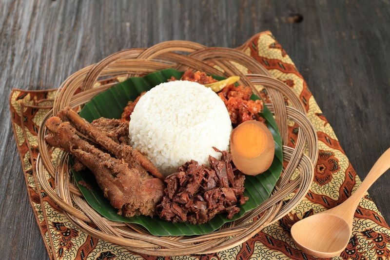 Nasi Gudeg Krecek is rice and gudeg, which is made from processed young jackfruit, coconut milk, spices, tofu, eggs and chicken. Yogyakarta specialties. Indonesian food. Served with banana leaves.