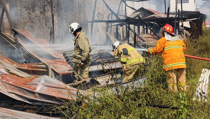 Personel Damkar Kota Semarang saat berjibaku memadamkan tiga rumah bedeng yang terbakar di Kelurahan Bugangan, Kecamatan Semarang Timur.