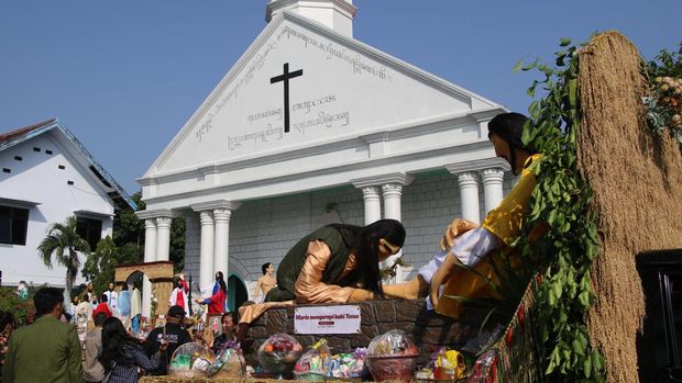 Warga beraktivitas di sekitar instalasi yang dihias dengan hasil bumi saat penyelenggaraan tradisi Riyaya Unduh-unduh di Gereja Kristen Jawi Wetan (GKJW) Mojowarno, Kabupaten Jombang, Jawa Timur, Minggu (10/5/2026). Instalasi pada kegiatan tradisi akulturasi Kristiani dan budaya Jawa yang digelar sebagai ungkapan syukur atas hasil panen dan berkat pemberian Tuhan YME ini diarak keliling kemudian dilelang, dan hasilnya dimanfaatkan untuk kebutuhan serta kesejahteraan gereja. ANTARA FOTO/Syaiful Arif