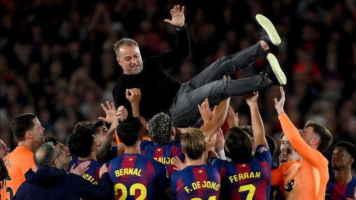 BARCELONA, SPAIN - MAY 10: Hansi Flick, Head Coach of FC Barcelona, is thrown in the air by players of FC Barcelona as they celebrate after defeating Real Madrid, and winning the LaLiga title, after the LaLiga EA Sports match between FC Barcelona and Real Madrid CF at Spotify Camp Nou on May 10, 2026 in Barcelona, Spain. (Photo by David Ramos/Getty Images)