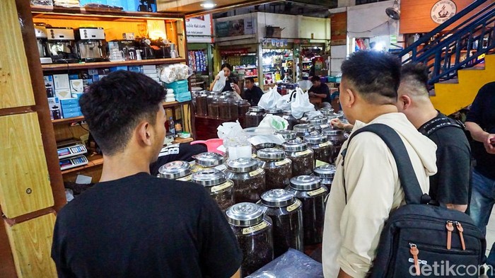 Penjual sibuk melayani pembeli kopi di Pasar Santa, Jakarta, Selasa (12/5/2026). Aktivitas jual beli terlihat ramai sejak pagi seiring meningkatnya minat masyarakat terhadap kopi.